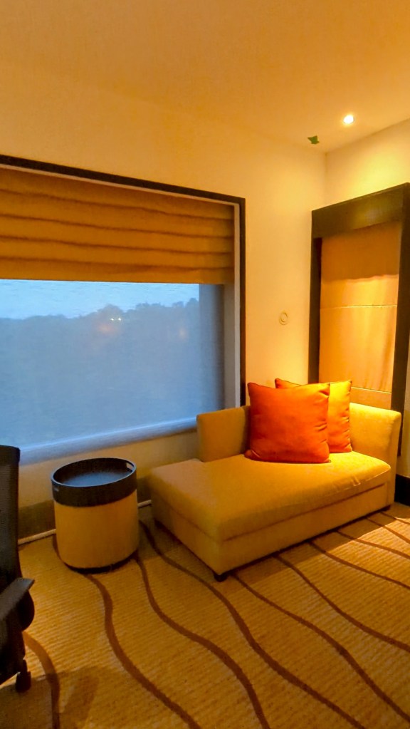 Couch placed by window at Sama Sama Hotel KL