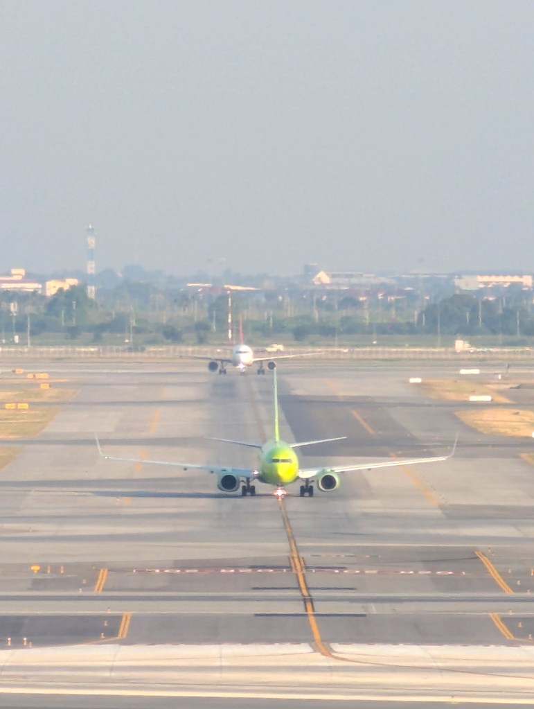 View of airplanes at Suvarnabhumi Airport from Siam Mandarina Hotel in Bangkok.