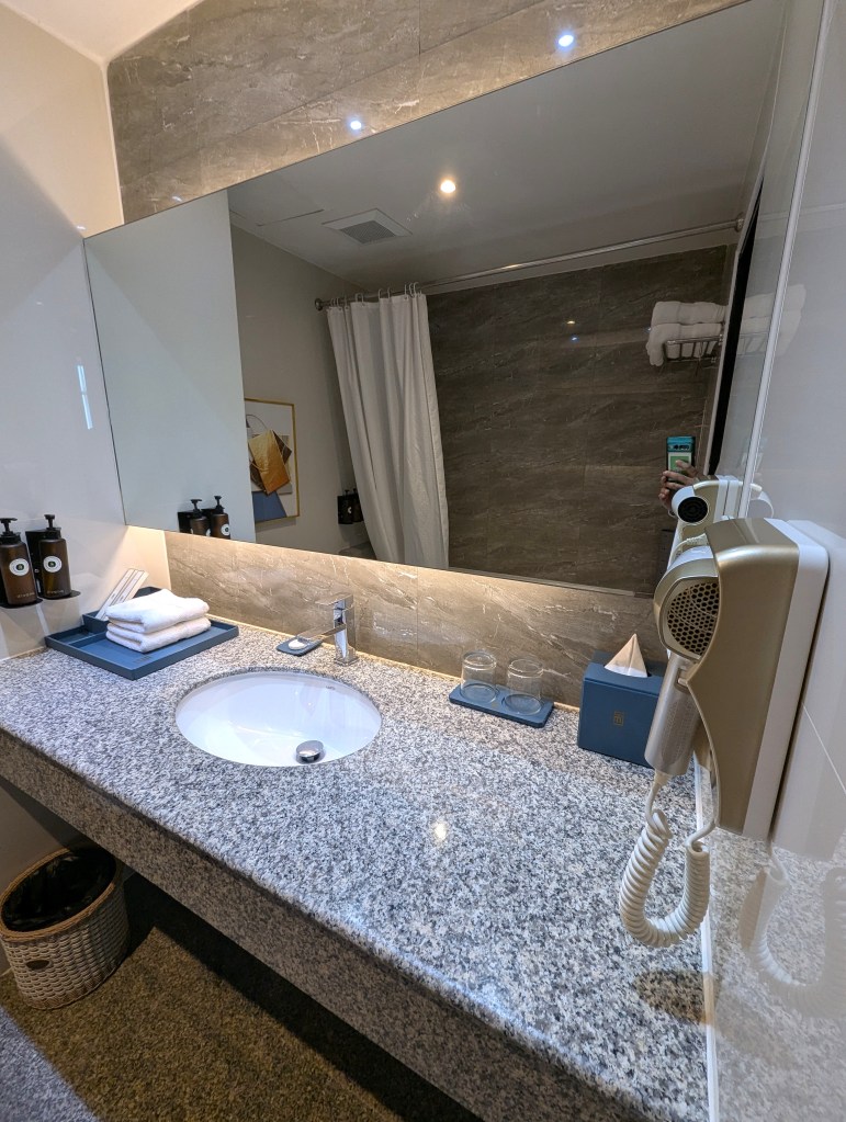 Sink space in Executive Suite bathroom of Siam Mandarina Hotel in Bangkok.
