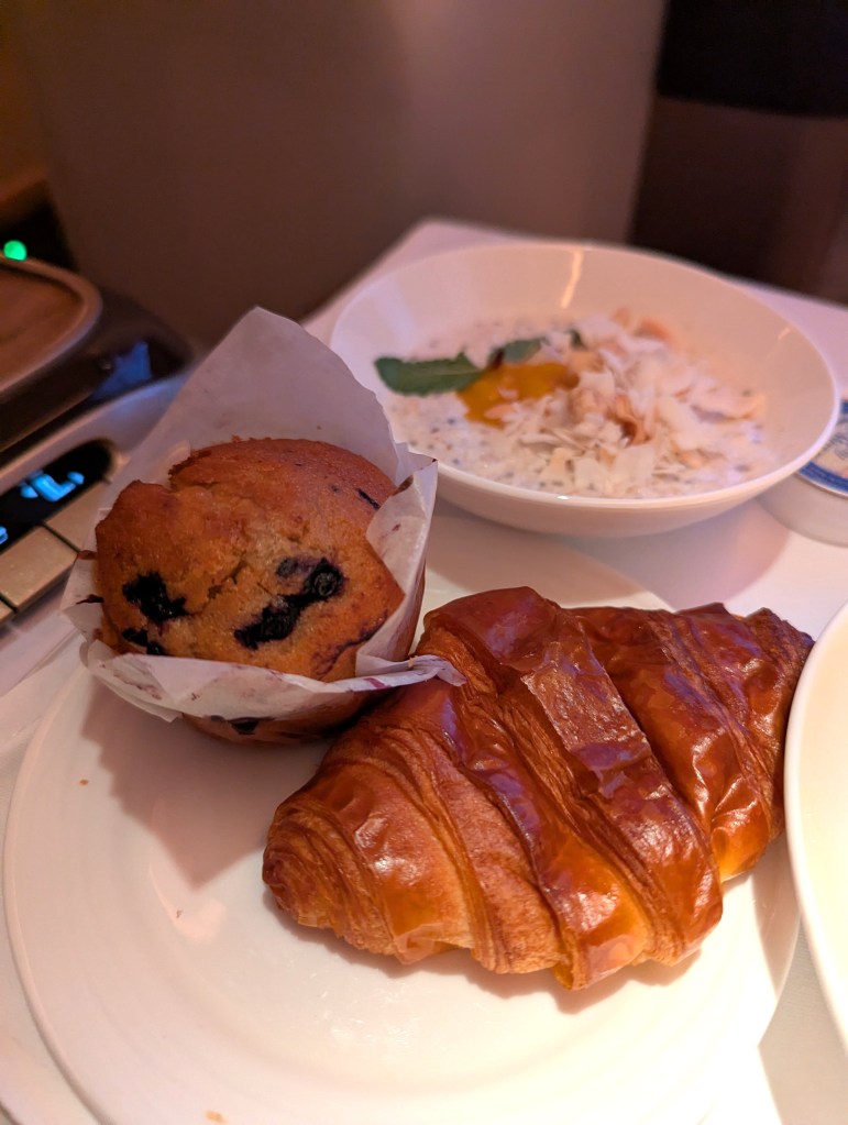 Croissant and blueberry muffin served during brunch in business class of Emirates Airlines