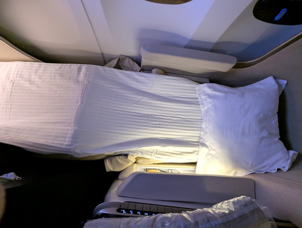 Mattress placed on full flat business class seat of Emirates Airlines