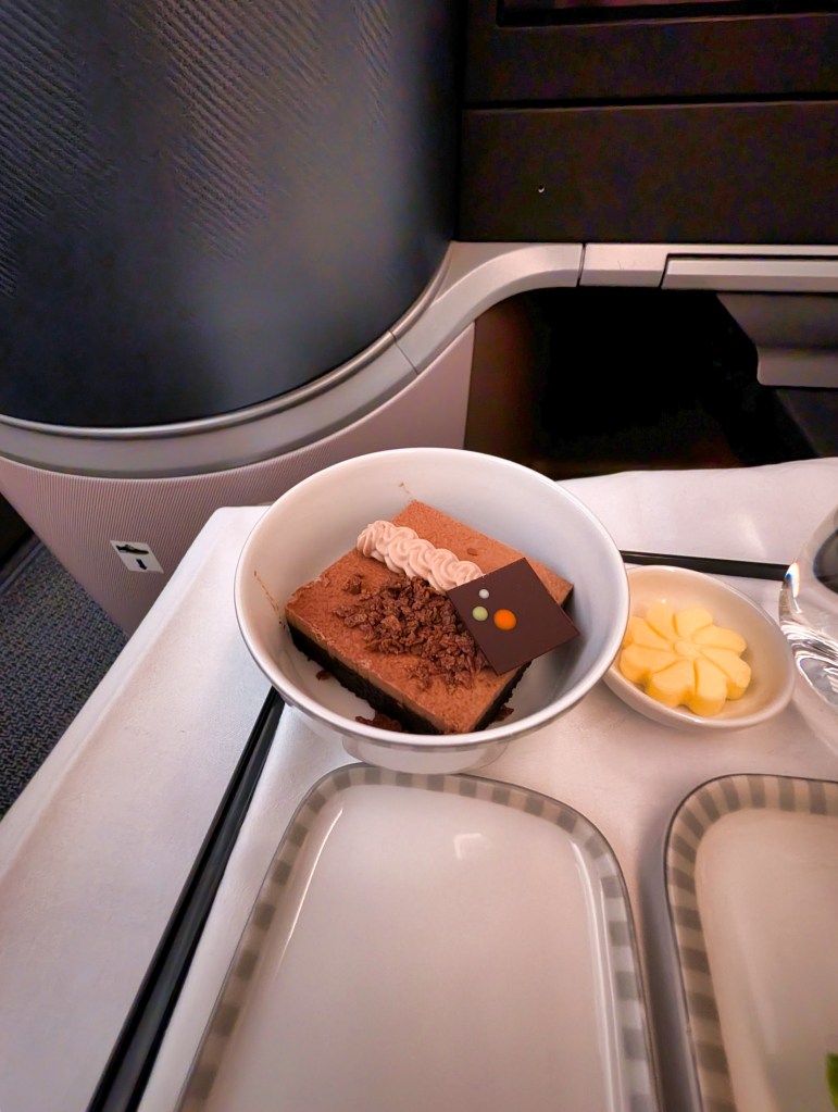 Milk chocolate cream cake with banana curd served on Singapore Airlines business class Singapore Airlines Business Class dessert of milk chocolate cream cake with banana curd
