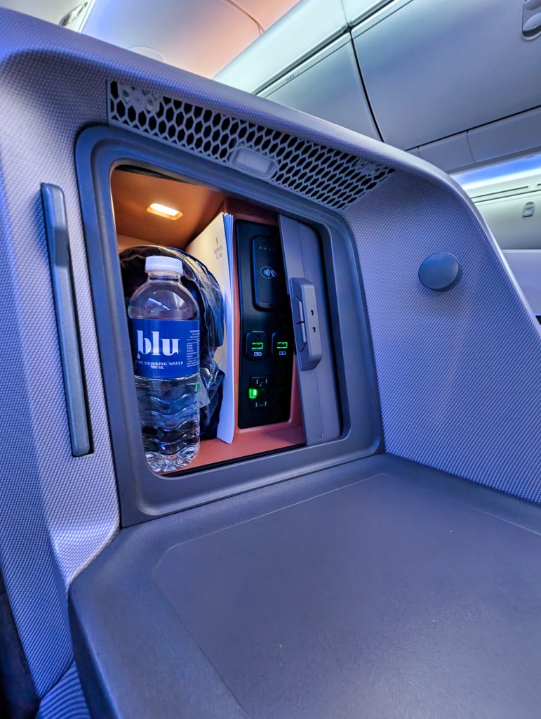 Storage area in regional business class seat of Singapore Airlines Small cubicle in seat of Singapore Airlines regional business class