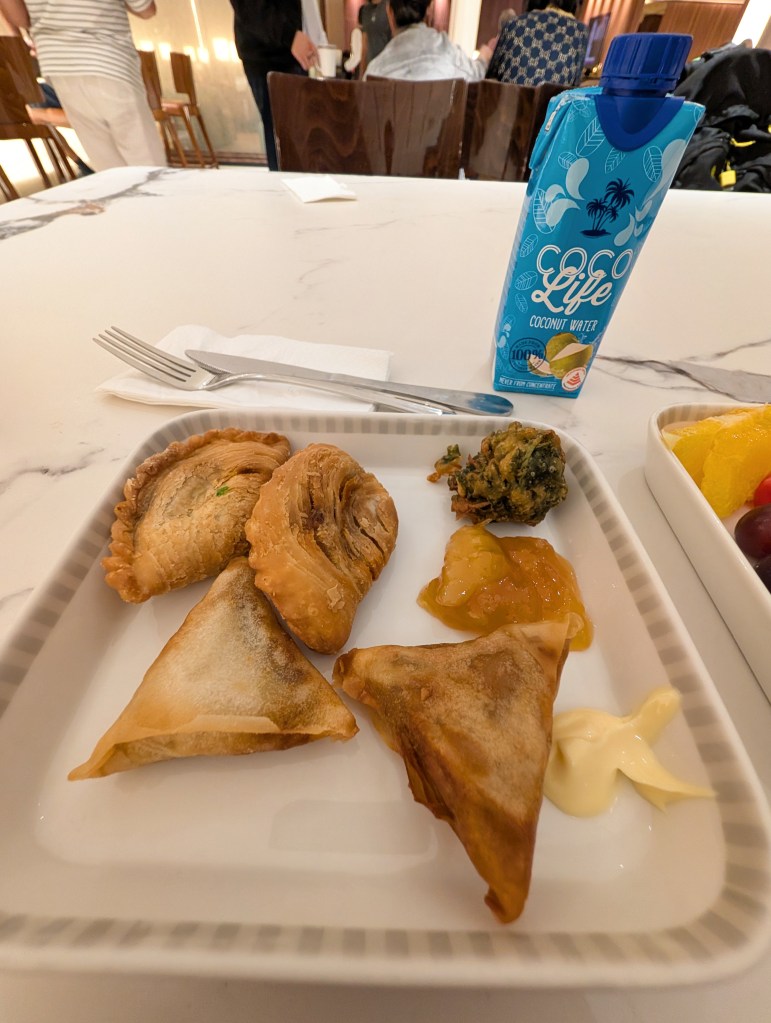 Plate of snacks and coconut drink from SilverKris Lounge T2 at Singapore Changi Airport Snacks from SilverKris Lounge Terminal 2 at Singapore Changi Airport