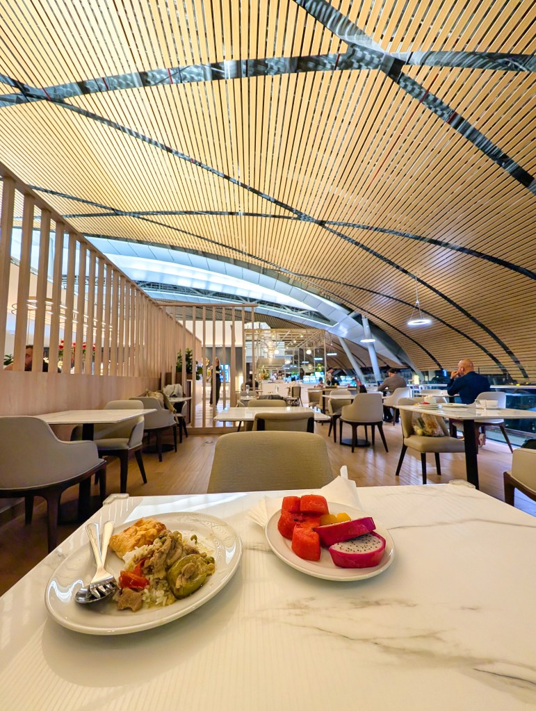 Food placed on table in the Miracle Business Class Lounge at Bangkok Suvarnabhumi International Airport Satellite 1