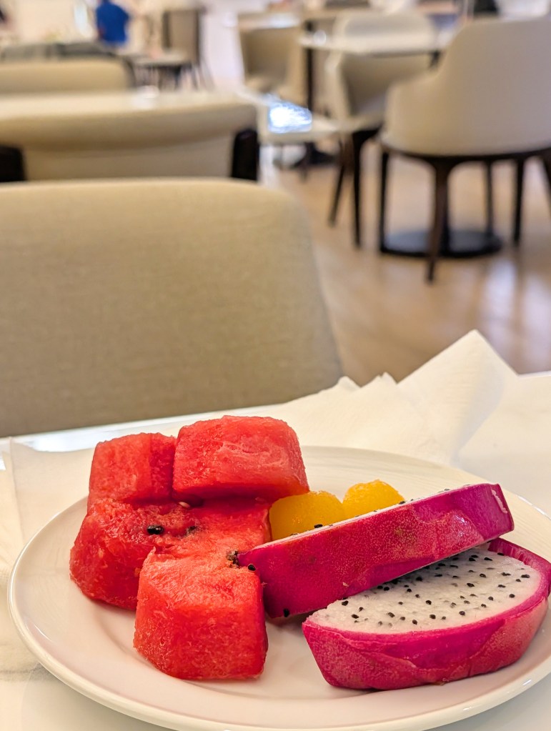 Watermelons and dragon fruits on plate in Miracle Business Class Lounge at Bangkok Suvarnabhumi International Airport in Satellite 1