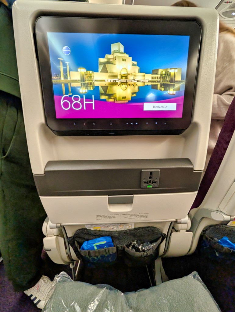Seat back and entertainment system screen on Qatar Airways economy class