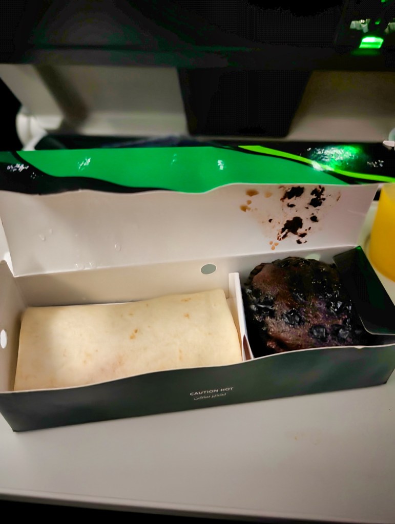 Wrap sandwich and chocolate muffin served in snack box on Qatar Airways economy class