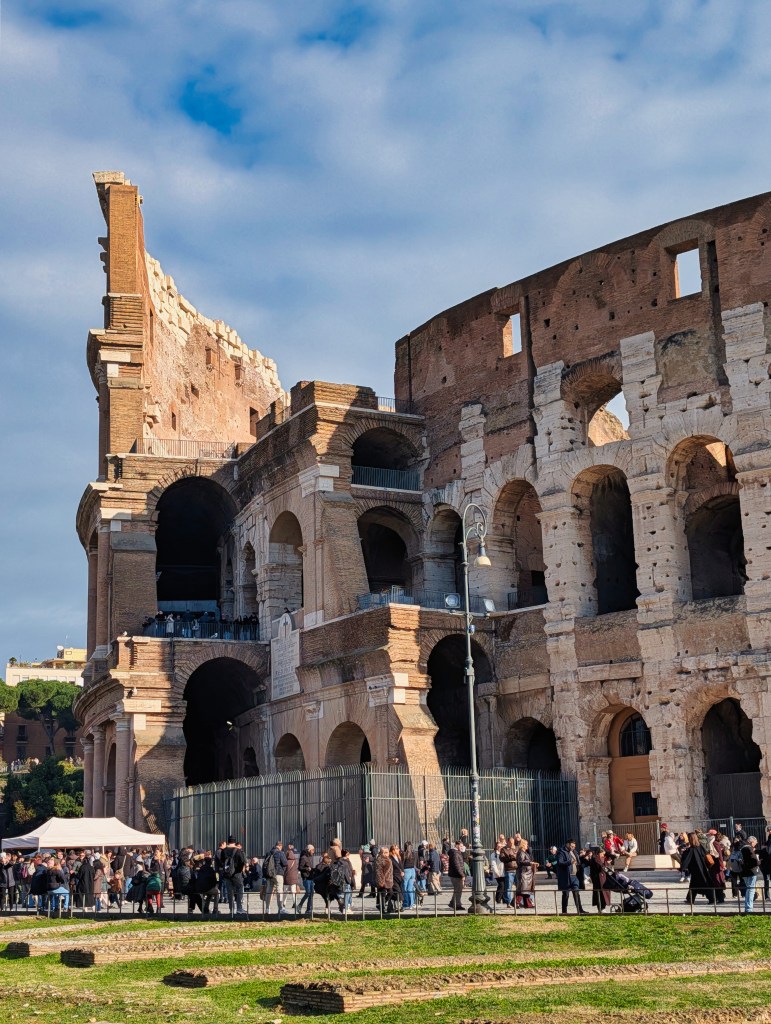 Tourists flocking around the Colosseum in Rome, Italy.