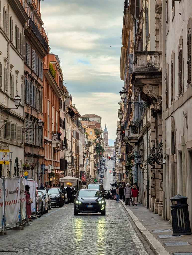 View of Via Sistina street in Rome, Italy with car on street.